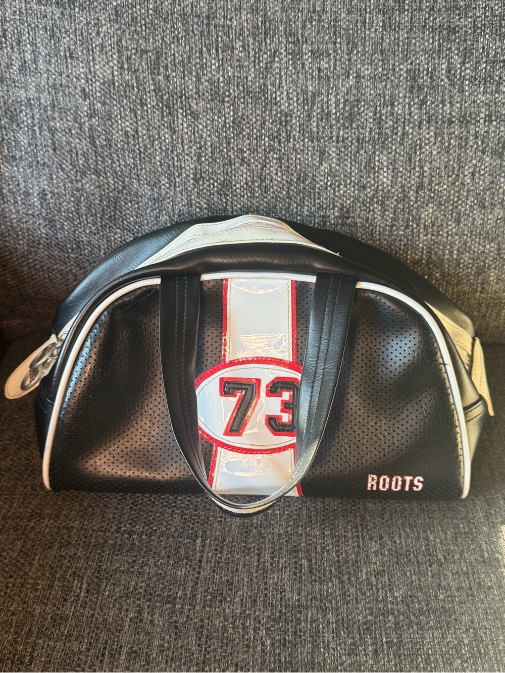 Roots Varsity 73 Bowling Bag Black Exterior With Red & White Striped Accents